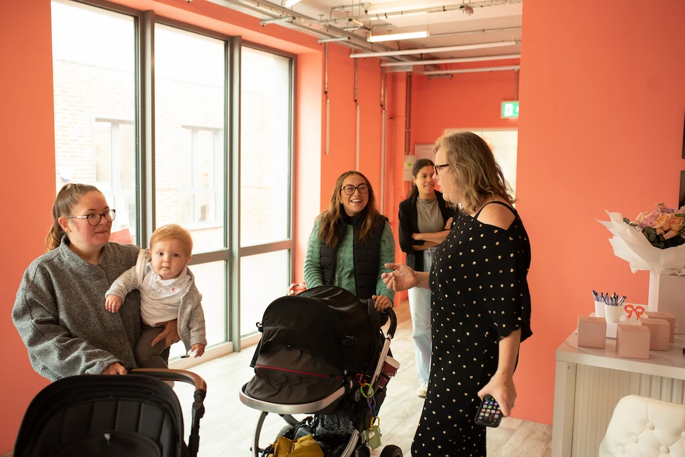 Staff welcoming parents into the child-care space