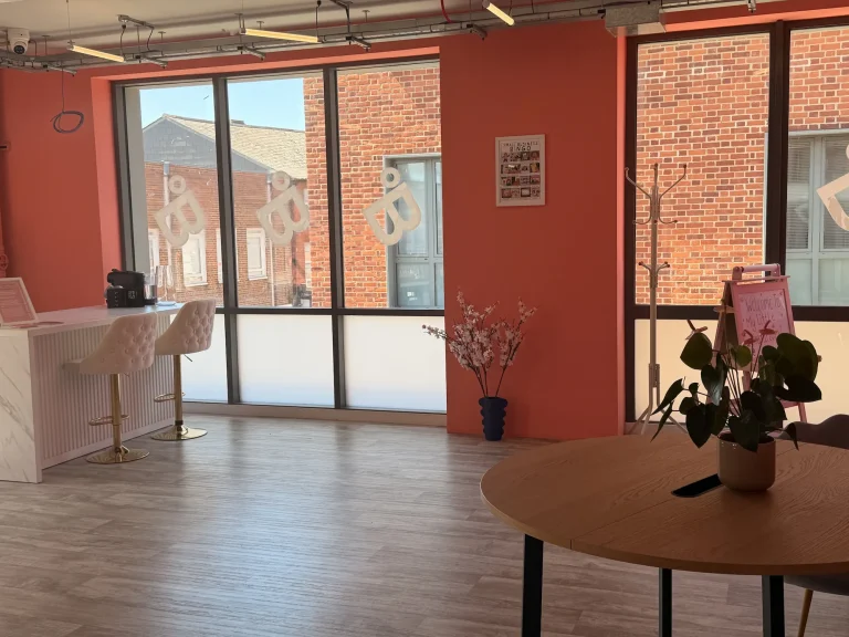 Sunlit co-working reception area with large windows