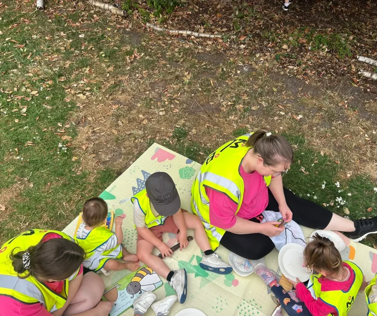 Children gathered with a nursery team member for outdoor learning
