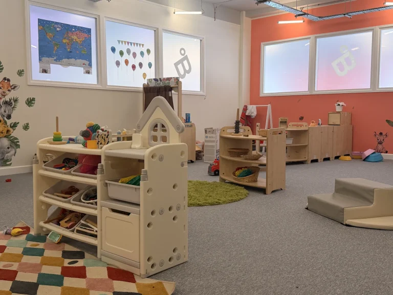 Low toy shelves and open play area in the nursery